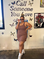 Load image into Gallery viewer, A woman modeling a fitted sleeveless active romper dress in a brown color,
