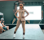 Load image into Gallery viewer, A model  wearing a beige zip-up one-piece jumpsuit, 
